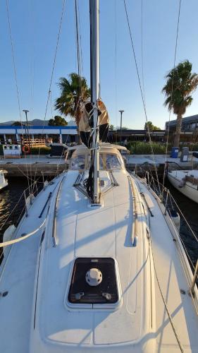 a white boat is docked at a dock at Nautical Nomads Yacht Charter in Tivat