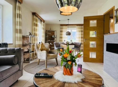a living room with a vase of flowers on a table at Relax-Bollendorf in Bollendorf