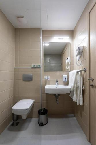 a bathroom with a sink and a toilet at Hotel Bela Jela in Lukovo
