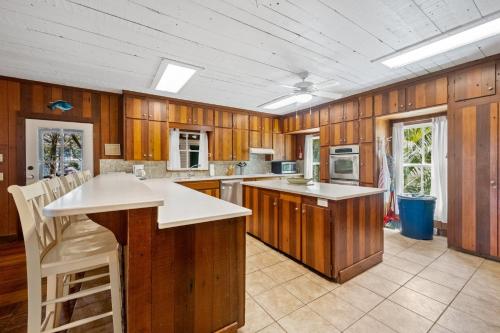 a large kitchen with wooden cabinets and a large island at Kitchens Creek home by Peace Vacations in Georgetown