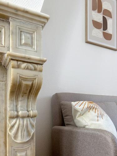 a bedroom with a bed and a chair and a picture at Le Léandre - Spacieux et central in Compiègne