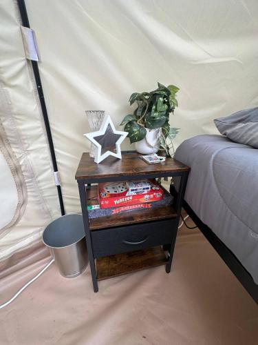 a nightstand with a star on it next to a bed at Stargaze at Crater Diamonds AR in Murfreesboro