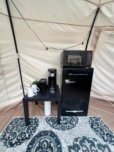 a microwave and coffee maker on a table in a tent at Stargaze at Crater Diamonds AR in Murfreesboro