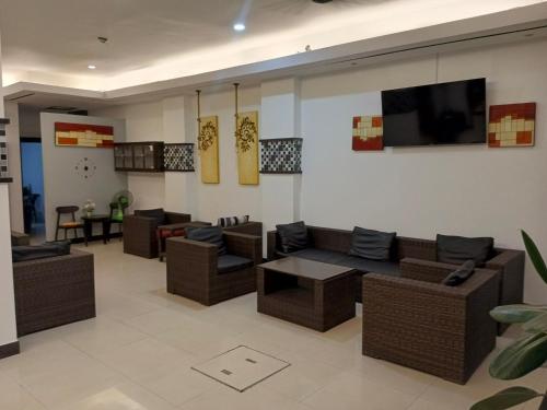 a living room with couches and a flat screen tv at The Star House in Patong Beach