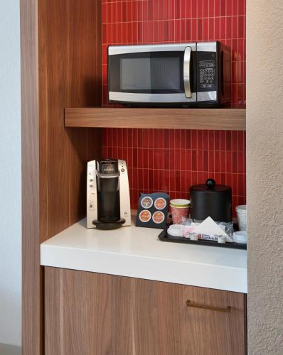 a microwave sitting on top of a kitchen counter at Hilton Garden Inn Detroit Downtown in Detroit