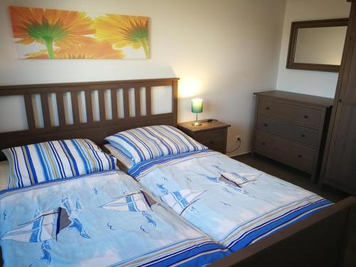 a bed with two pillows on it in a bedroom at Nike -barrierearm- in Burg auf Fehmarn