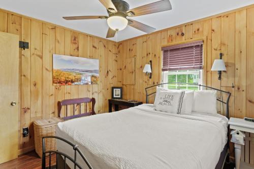 a bedroom with a bed and a ceiling fan at Takundewide Retreat in Queensbury