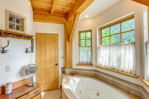 a large bathroom with a tub and a window at Steps From Natl Forest Creekside Home in Durango in Durango