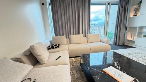 a living room with a couch and a glass table at Livingstones III - Henry's 411 - 2P - Shared Kitchen in Luxembourg
