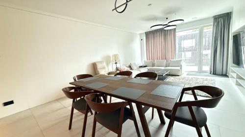 a dining room and living room with a table and chairs at Livingstones III - Henry's 411 - 2P - Shared Kitchen in Luxembourg