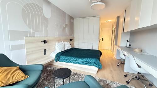 a bedroom with a bed and a desk and a couch at Livingstones III - Henry's 411 - 2P - Shared Kitchen in Luxembourg