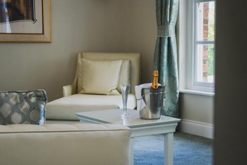 a living room with a couch and a table at Park Hall Hotel and Spa Wolverhampton in Wolverhampton