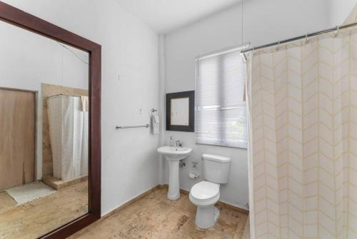 a bathroom with a toilet and a sink and a shower at Casa Loba Suite 2 at 413 with private pool in Rincon