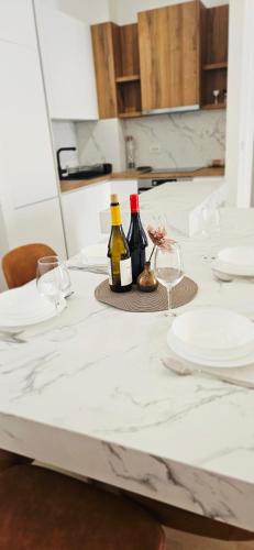 a table with two bottles of wine and glasses at ROYAL Residences in Cetinje