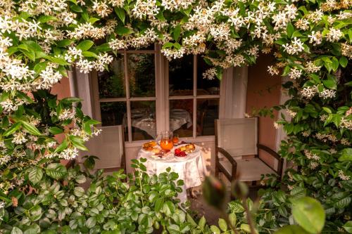 a table with a plate of food on it with flowers at Villa Bricco dei Cogni in La Morra
