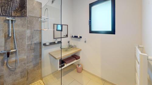 a bathroom with a shower and a glass shower stall at CARPE DIEM Résidence Hôtelière in Lorgues
