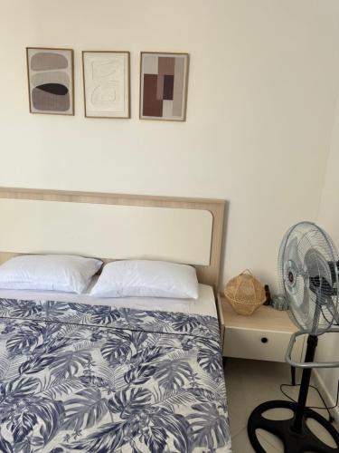 a bedroom with a bed and a fan at Fès comfort stay in Fès