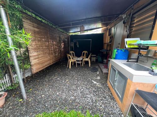 a small backyard with two chairs and a table at Two-Bedroom Townhouse Camella Bacolod South in Bacolod