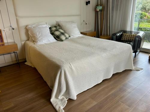 a bedroom with a bed with a blanket on it at Studio Design Chic à Chiberta - plage & green in Anglet