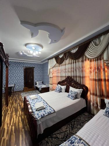 a bedroom with two beds in a room with curtains at 中国民宿 in Bukhara