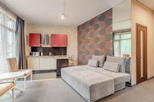 a bedroom with a large bed and a kitchen at Bukovel Apart in Bukovel