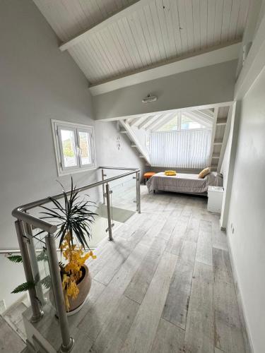 a living room with a staircase and a couch at Casa en Cumbres in Ushuaia