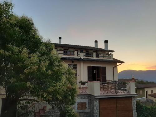 a house with a balcony on top of it at Le Coppare GuestHouse in Tazzo