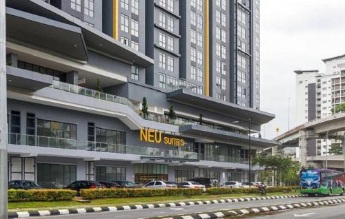 a new sites building with cars parked in front of it at Neu Suites Near KLCC in Kuala Lumpur