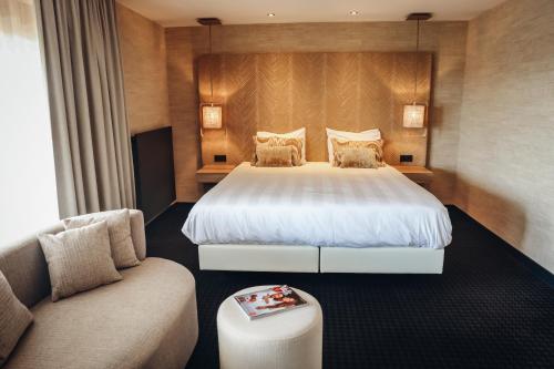 a hotel room with a bed and a couch at Van der Valk Hotel Akersloot / A9 ALKMAAR in Akersloot