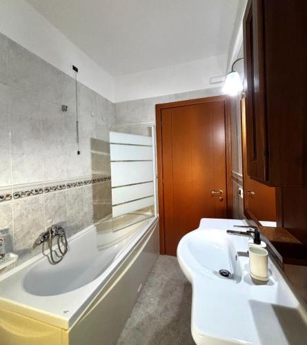 a bathroom with a white tub and a sink at Dimora Speranza in San Giovanni Teatino