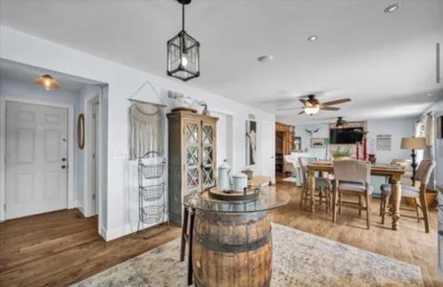 a living room with a table and a dining room at Lake House with private beach in Putnam