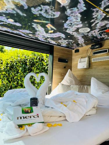 a hotel room with a bed with swans made out of towels at Relax-Bollendorf in Bollendorf