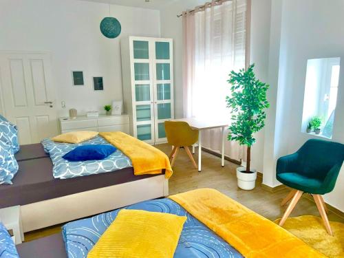 a bedroom with two beds and a desk and a chair at Relax Fewo in Hagen