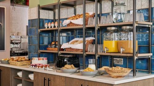 a kitchen with a counter with bread and other foods at Fraser Suites Glasgow in Glasgow