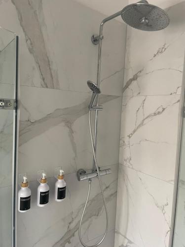 a bathroom with a shower with two soap bottles at NEU- APPARTMENT in HAGEN nähe DORTMUND - 3 Parking! 3 Double-Bed! 2 Bedrooms, WIFI, COFFEMASHINE-Fully Automatic, KITCHEN, NETFLIX,DISNEY,MAGENTA in Hagen