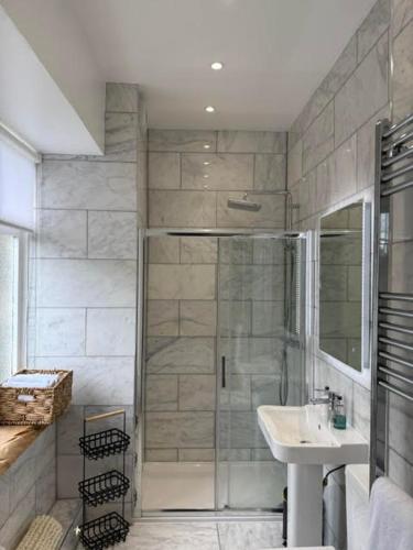 a bathroom with a shower and a sink at Limefield Mansion House in Livingston