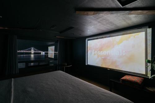 a bedroom with a large projection screen with a bridge at All New Diamond House in Busan