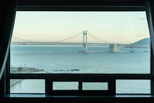 a view of a bridge from a window at All New Diamond House in Busan