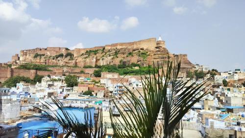 a view of a city with a mountain in the background at Castle View Haveli in Jodhpur
