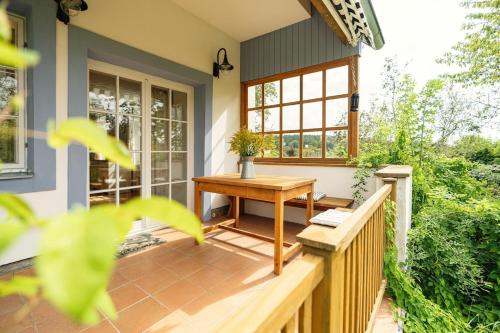a porch of a house with a wooden table at Venkovský dům V Sadu 