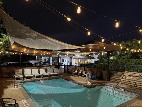 a swimming pool at night with lights on a patio at Days Inn by Wyndham Arlington in Arlington
