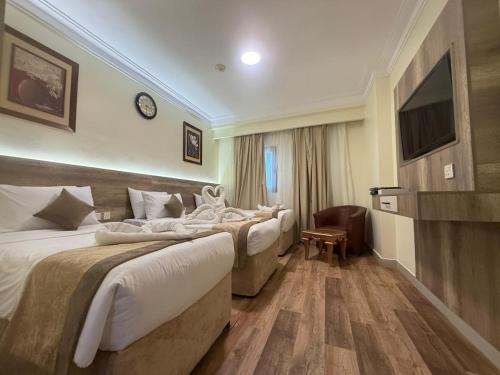 Postel nebo postele na pokoji v ubytování فندق مأثر الاندلس - Maather Alandalus Hotel