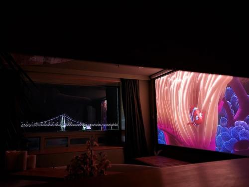 a large flat screen tv in a living room at All New Diamond House in Busan