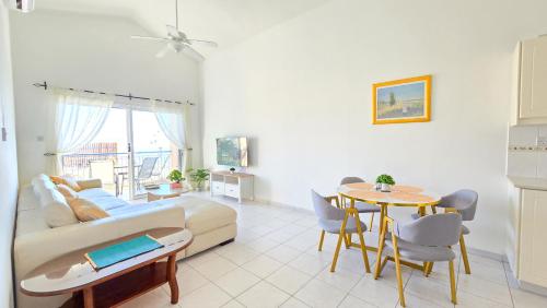 a living room with a couch and a table at CSS Cosmic Smart Superior Sea View Tala in Tala