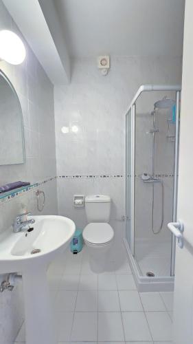 a bathroom with a shower and a toilet and a sink at CSS Cosmic Smart Superior Sea View Tala in Tala