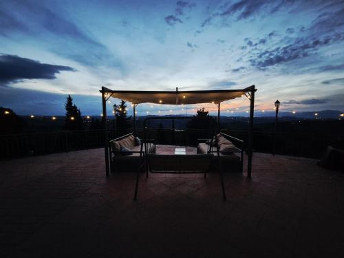 a gazebo with two beds on a patio at night at Villa Tutti i colori del Chianti in Linari