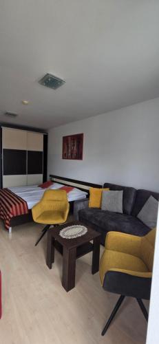 a living room with a couch and a bed at Apartmán AQUAPARK - Hotel Bešeňová in Bešeňová