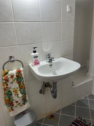 a bathroom with a sink and a towel at Sunshine 1 in Leonidio