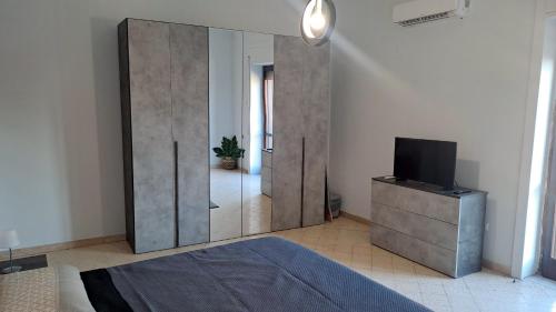 a bedroom with a large wooden partition with a tv at Domus Angelina Pompei in Pompei