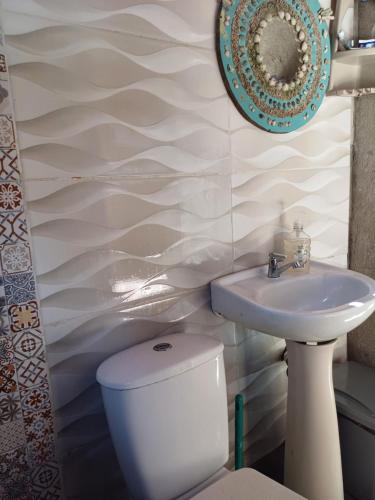 a bathroom with a toilet and a sink at CARDUMEN Arte y Cocina in Playa Blanca